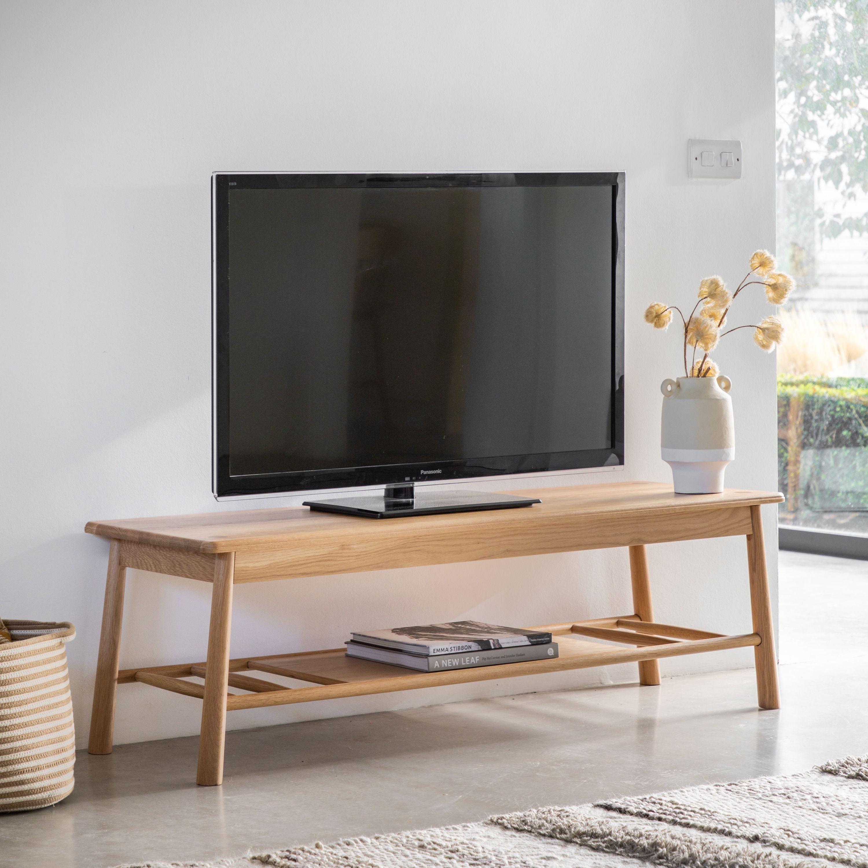 Wooden TV stand with shelf.